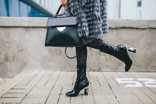 close-up-accessories-details-stylish-woman-walking-city-warm-fur-coat-winter-season-cold-weather-holding-leather-handbag-legs-boots-footwear-street-fashion-trend_285396-4720